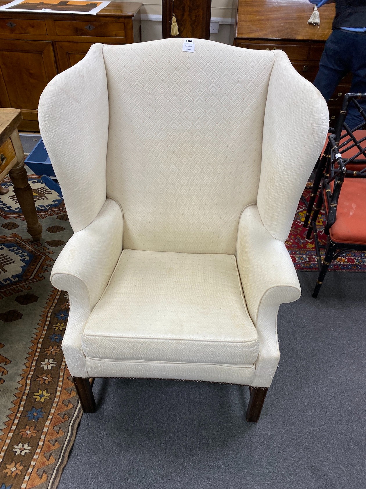 A George III style mahogany framed upholstered wing armchair, width 80cm, depth 64cm, height 122cm